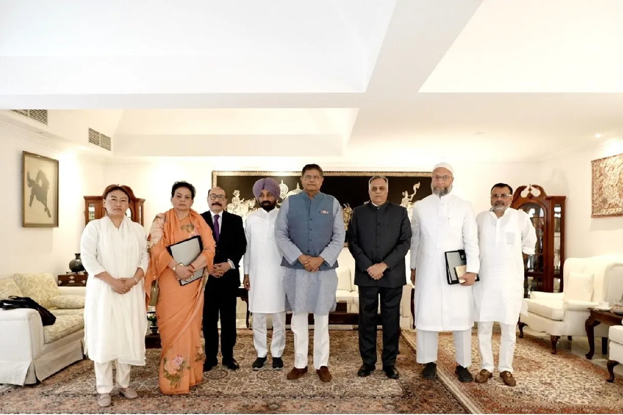 Eight members of the all-party parliamentary delegation standing in a row in a formal sitting room, with Baijayant Panda in a grey waistcoat near the centre