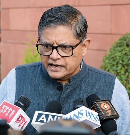 Baijayant Panda in a grey bandhgala jacket speaking to reporters in front of microphones from PTI, ANI, IANS and Doordarshan